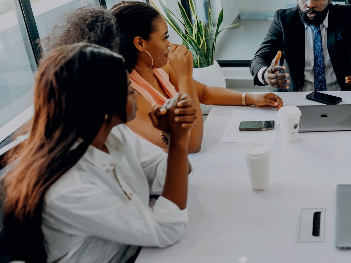 Teimetra team members collaborating around a boardroom table during a client engagement